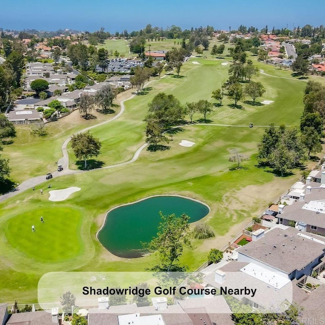 drone / aerial view featuring golf course view and a residential view