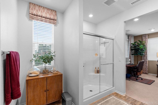 bathroom featuring recessed lighting, visible vents, a shower stall, and baseboards