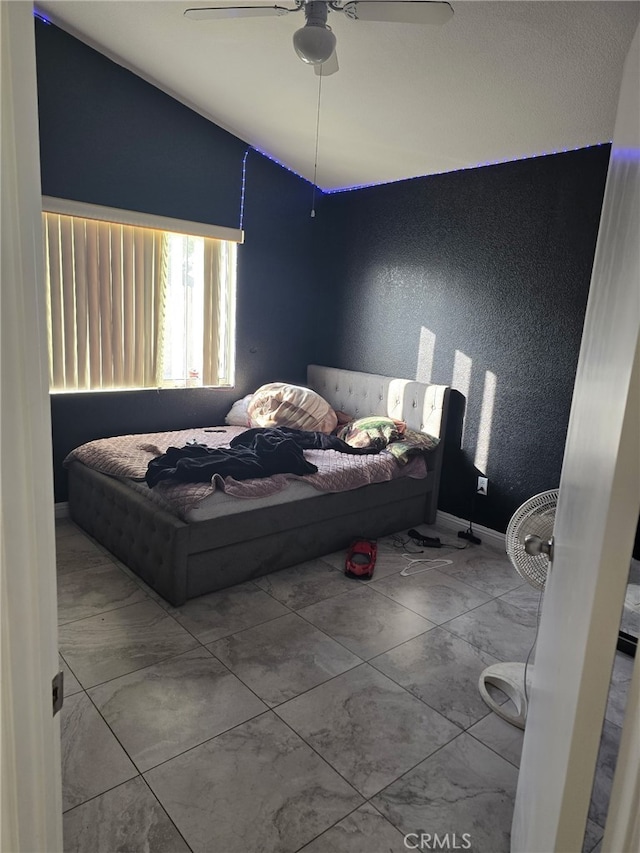 bedroom featuring ceiling fan and vaulted ceiling