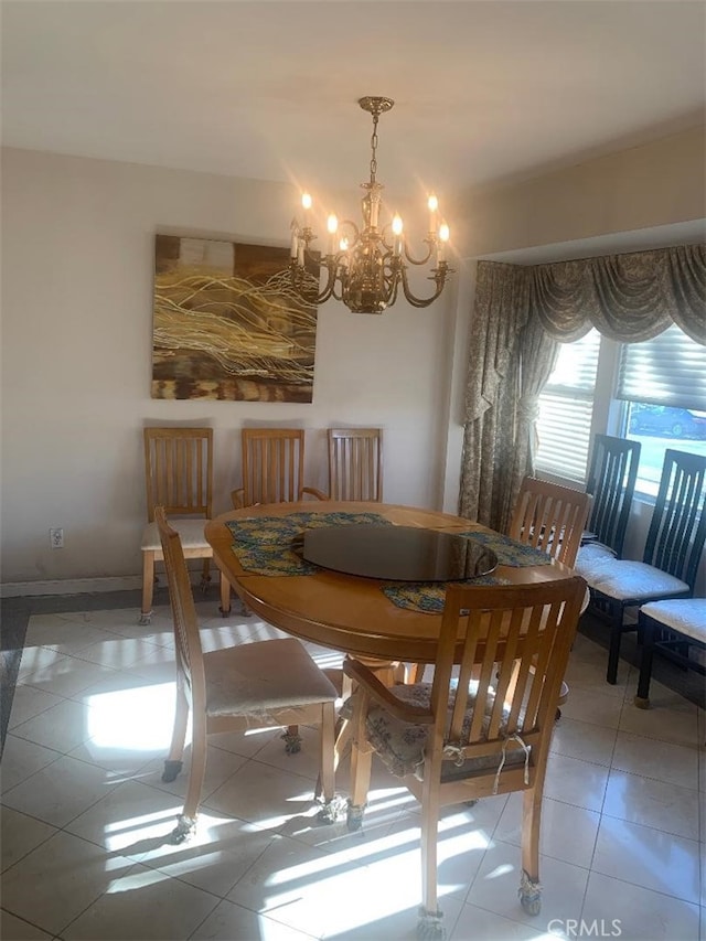 dining area featuring tile patterned flooring and an inviting chandelier