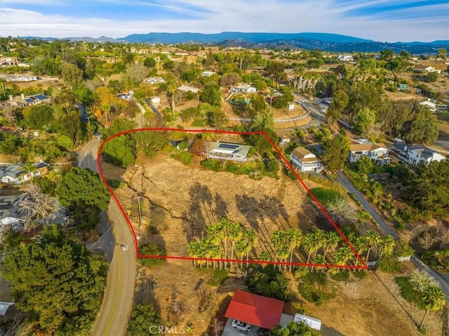 birds eye view of property with a mountain view