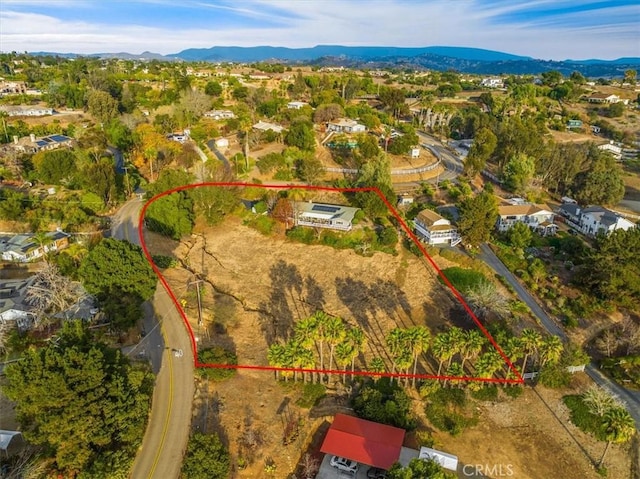 birds eye view of property featuring a mountain view