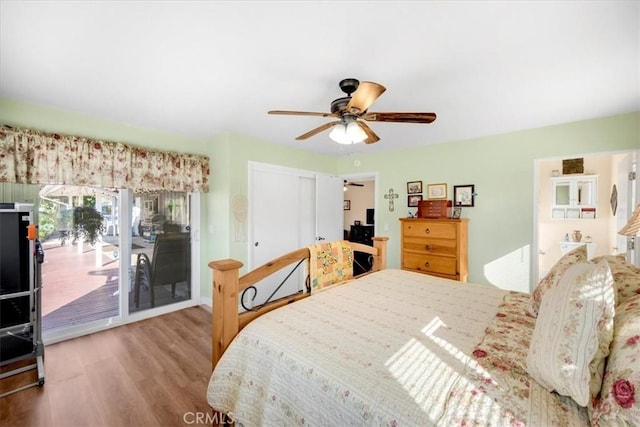 bedroom with access to exterior, ceiling fan, a closet, and wood finished floors