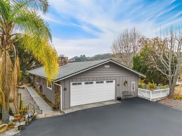 garage featuring aphalt driveway