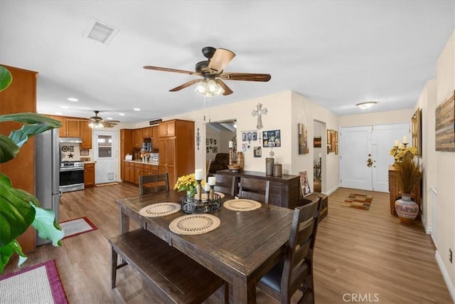 dining room featuring a ceiling fan, recessed lighting, visible vents, and wood finished floors