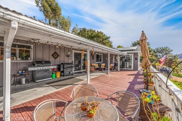 deck featuring area for grilling and outdoor lounge area