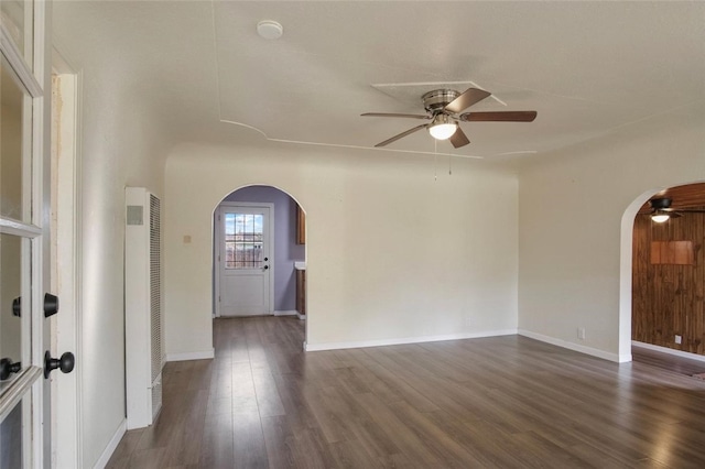 empty room featuring ceiling fan and dark hardwood / wood-style floors