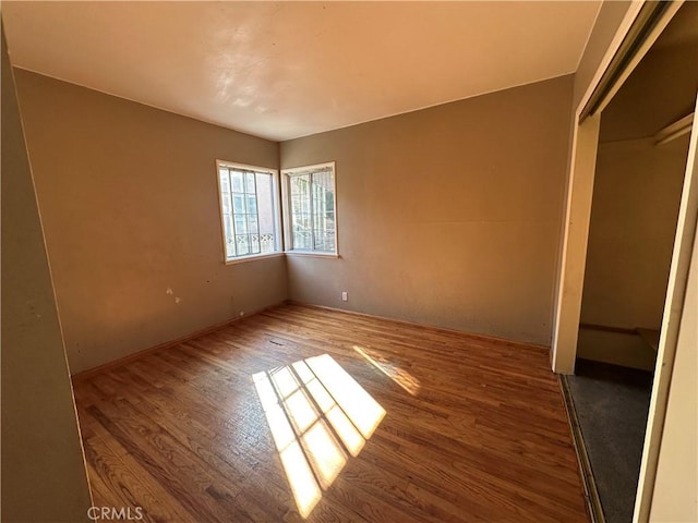 unfurnished bedroom with hardwood / wood-style floors