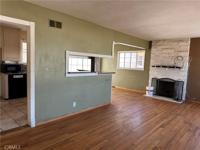 unfurnished living room featuring a fireplace and light wood-type flooring