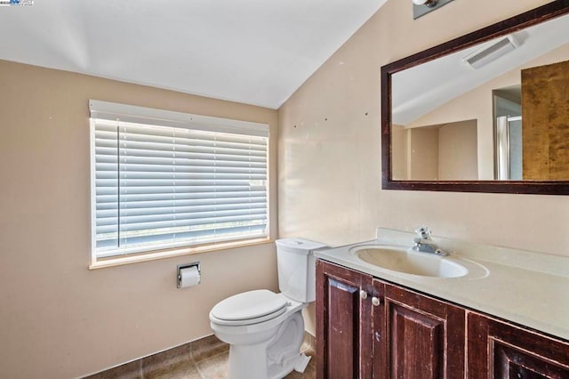 bathroom featuring a shower with door, vanity, lofted ceiling, and toilet