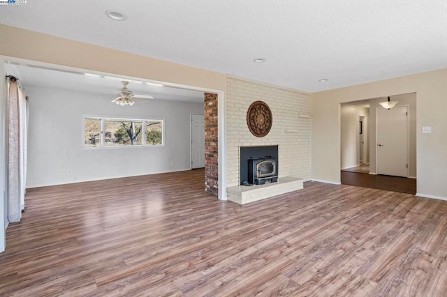 unfurnished living room featuring ceiling fan and hardwood / wood-style floors