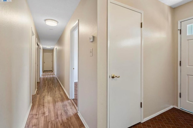 corridor featuring hardwood / wood-style flooring