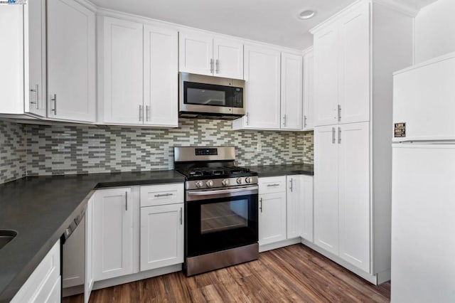 kitchen featuring white cabinetry, appliances with stainless steel finishes, dark hardwood / wood-style flooring, and tasteful backsplash