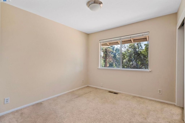 unfurnished room with light colored carpet