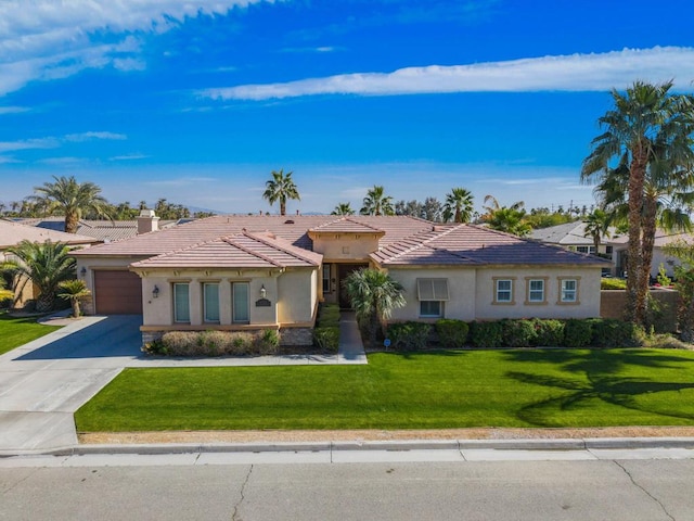 view of front of house with a garage and a front lawn