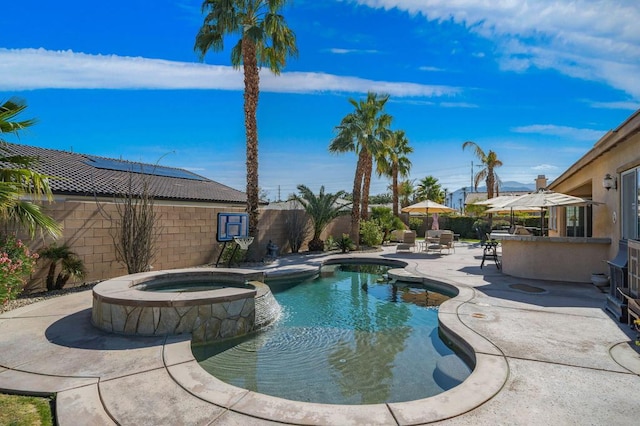 view of pool featuring an in ground hot tub and a patio