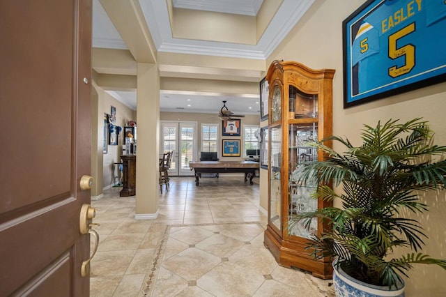 tiled foyer entrance with crown molding and ceiling fan