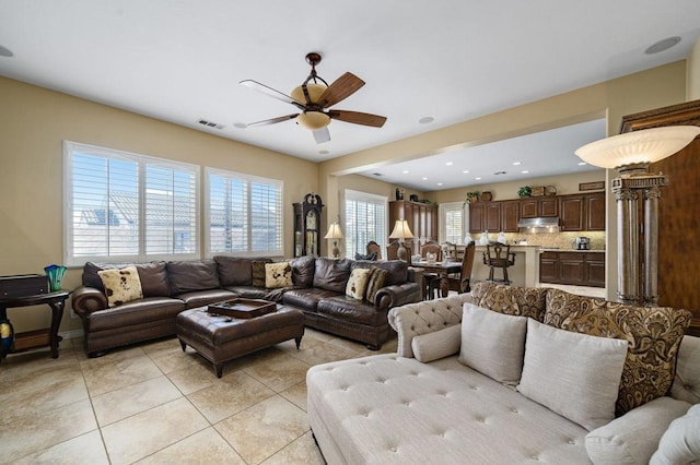 tiled living room with ceiling fan