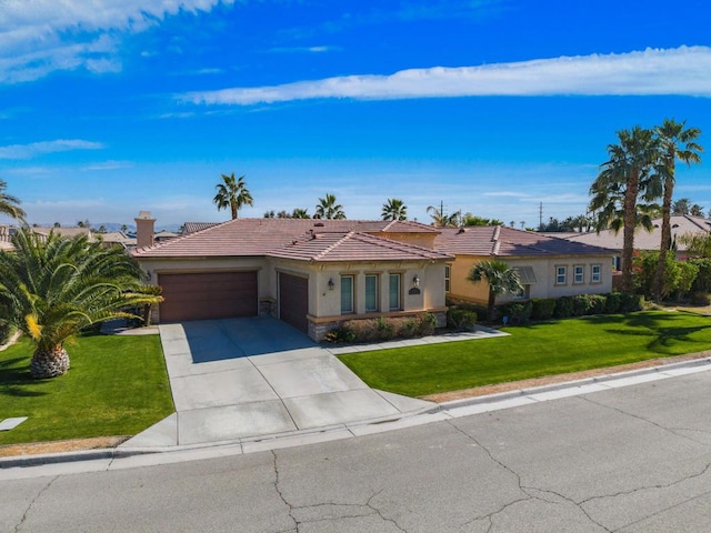 single story home with a garage and a front yard