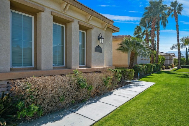 doorway to property with a yard