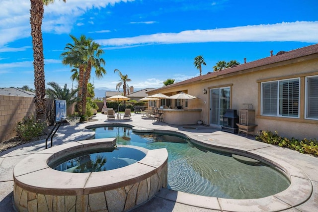 view of pool featuring an in ground hot tub, grilling area, exterior bar, and a patio