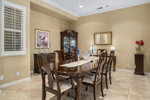 tiled dining room with crown molding