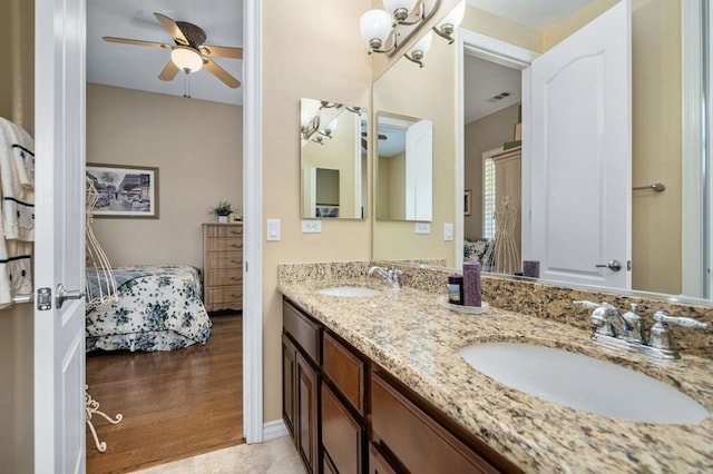 bathroom featuring hardwood / wood-style flooring, ceiling fan, and vanity