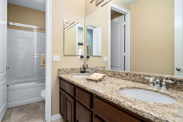 full bathroom featuring vanity, shower / bath combination with glass door, and toilet