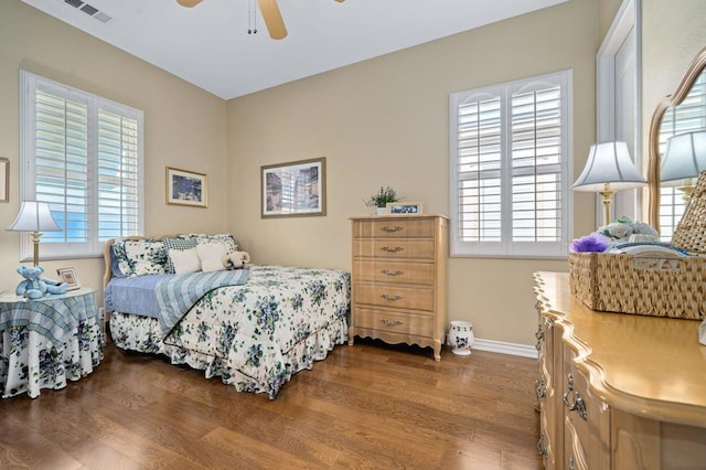 bedroom with hardwood / wood-style flooring, ceiling fan, and multiple windows