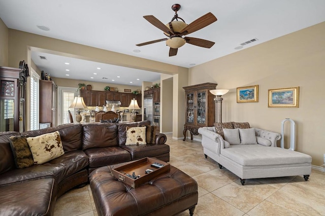 tiled living room with ceiling fan