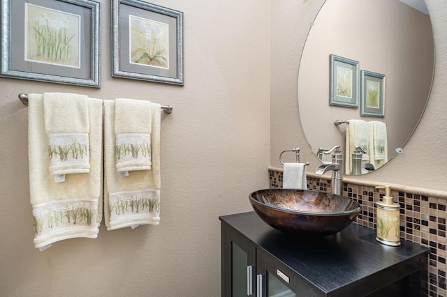 bathroom featuring vanity and decorative backsplash