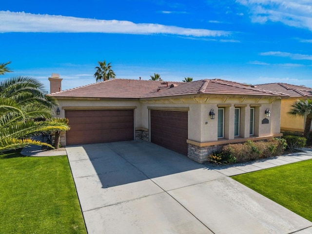 view of front of property featuring a garage and a front yard