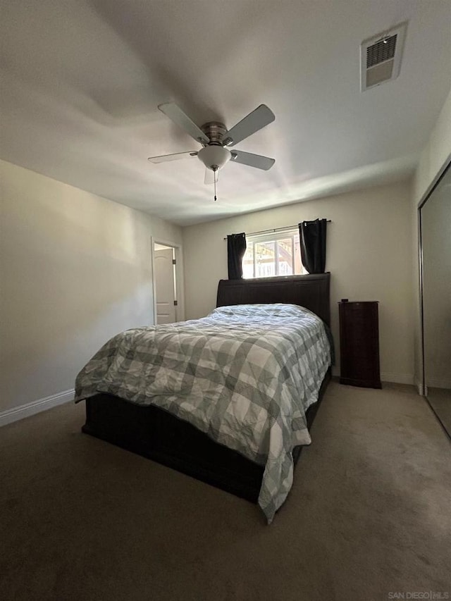 carpeted bedroom with ceiling fan and a closet