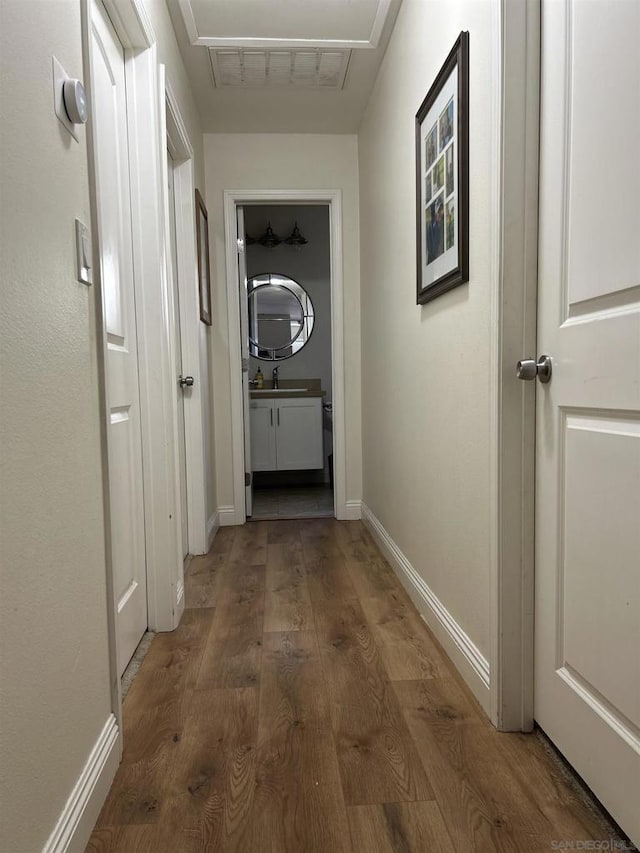 hallway featuring dark hardwood / wood-style flooring and sink