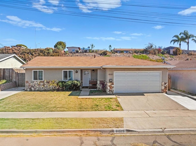 ranch-style home with a garage and a front lawn