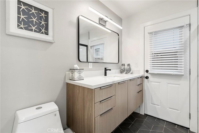 bathroom with tile patterned floors, toilet, and vanity