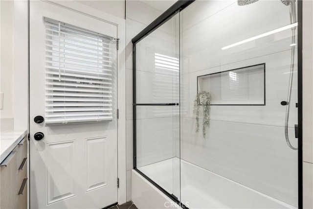 bathroom with vanity and bath / shower combo with glass door