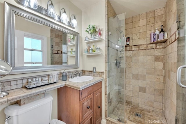 bathroom with vanity, an enclosed shower, and toilet