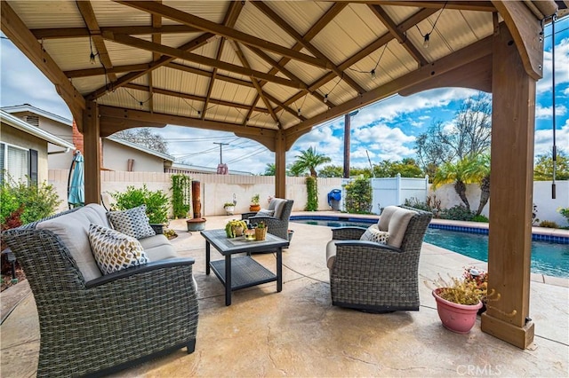 view of patio with a fenced in pool, a gazebo, and an outdoor hangout area