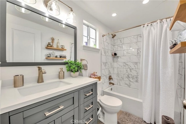 full bathroom featuring shower / bath combo, vanity, and toilet