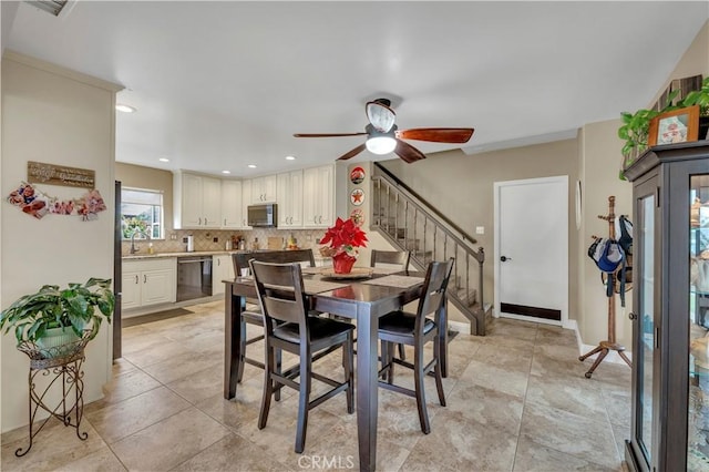 dining room featuring sink and ceiling fan