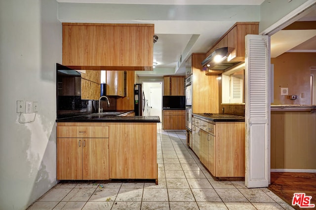 kitchen with stainless steel appliances, extractor fan, sink, and light tile patterned flooring