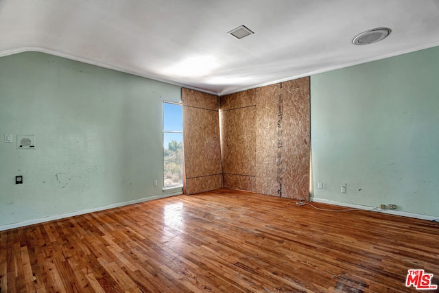 unfurnished room with wood-type flooring