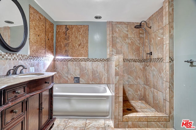 bathroom with independent shower and bath, vanity, tile walls, and decorative backsplash