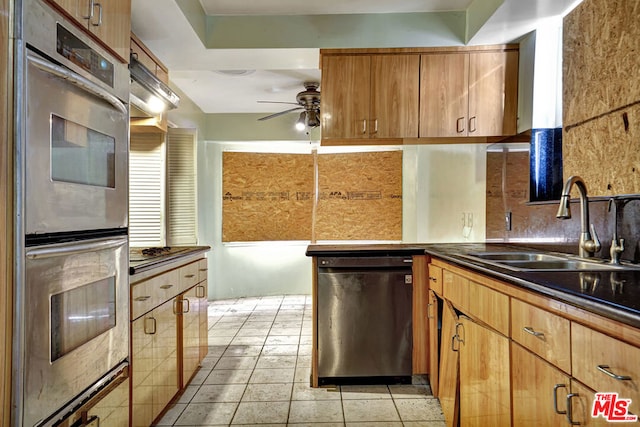 kitchen featuring sink, dishwasher, ceiling fan, stainless steel double oven, and backsplash