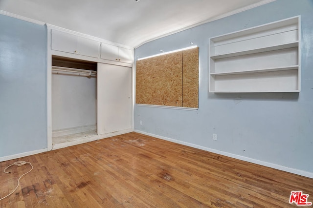 unfurnished bedroom featuring wood-type flooring and a closet