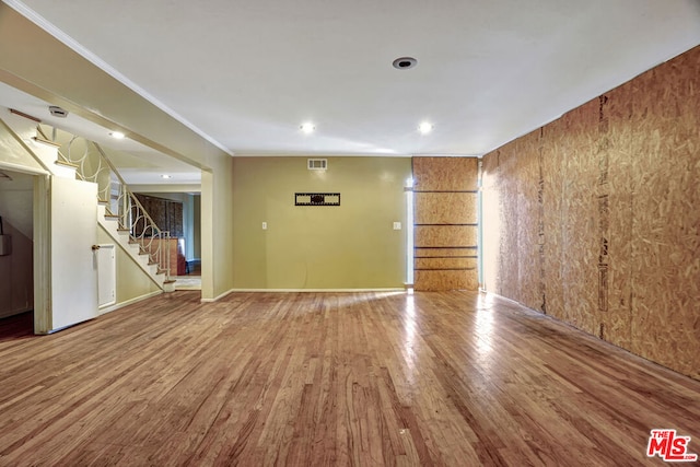 unfurnished room featuring hardwood / wood-style flooring and crown molding