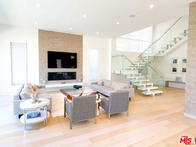 living room with a large fireplace and light hardwood / wood-style floors