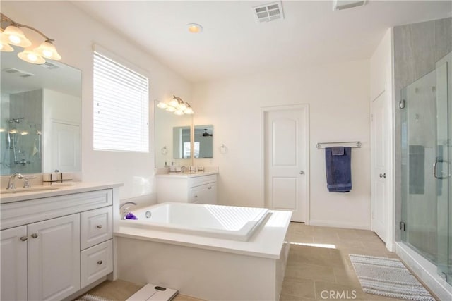 bathroom featuring vanity, separate shower and tub, and tile patterned floors