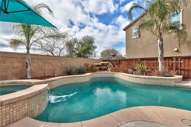 view of swimming pool featuring pool water feature and an in ground hot tub